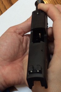 Sig P290 Field Stripping Instructions, Step 2: Reach under with your other hand and press the "button" end of the lever, until it pops out the left side of the gun. S-L-O-W-L-Y let the slide move forward and off the end.